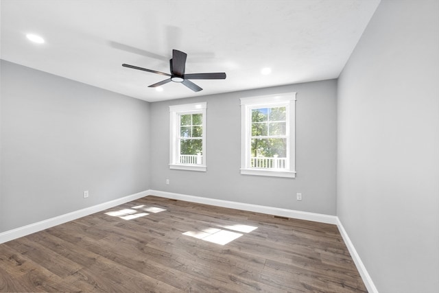 spare room with ceiling fan and wood-type flooring