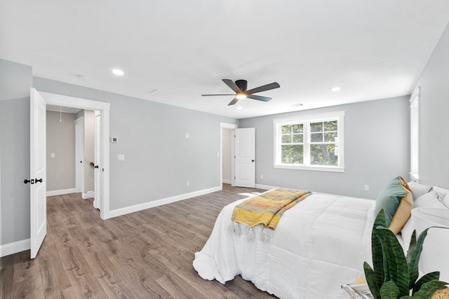 bedroom with ceiling fan and hardwood / wood-style flooring