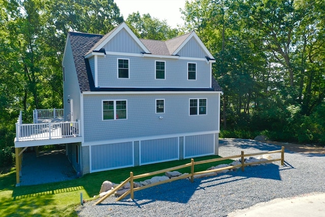 rear view of property with a deck and a lawn