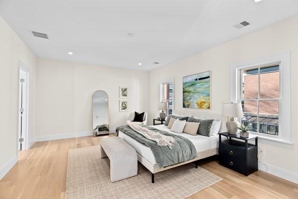 32 Kingsbury St Unit 1, Wellesley, MA 02481 - bedroom with light wood-style floors, arched walkways, and recessed lighting