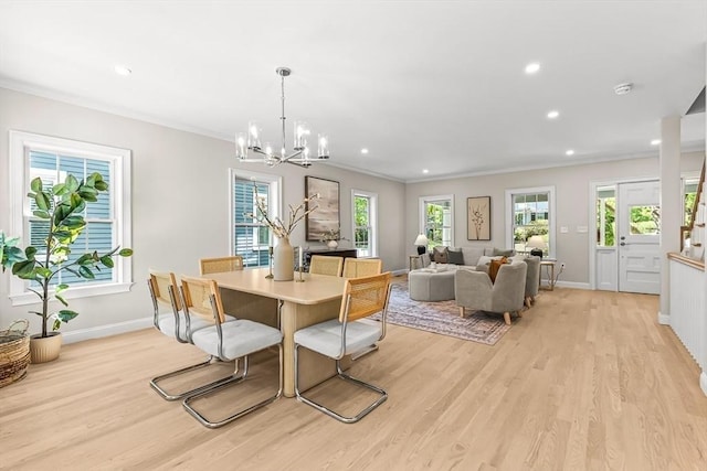 dining space with an inviting chandelier, baseboards, and light wood finished floors