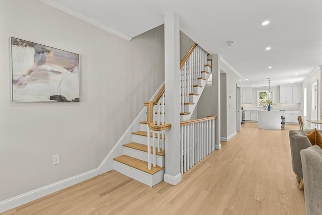 stairs featuring crown molding, recessed lighting, baseboards, and wood finished floors