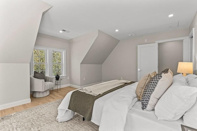 bedroom with baseboards, recessed lighting, wood finished floors, and lofted ceiling