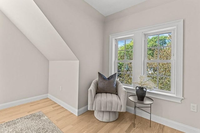 sitting room with baseboards and wood finished floors