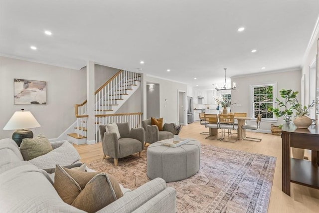 living room with crown molding, recessed lighting, stairs, and a notable chandelier
