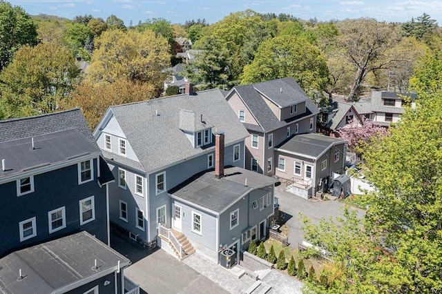 aerial view featuring a wooded view and a residential view