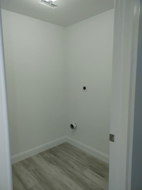 washroom with laundry area, electric dryer hookup, baseboards, and wood finished floors