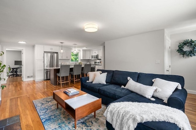23 Redbird Rd, Wrentham, MA 02093 - living area featuring light wood-type flooring and baseboards
