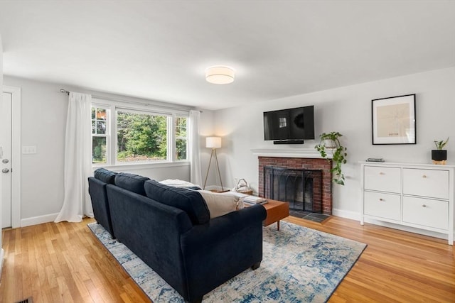 23 Redbird Rd, Wrentham, MA 02093 - living room with light wood finished floors and a fireplace