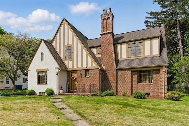 96 Craiwell Ave, West Springfield, MA 01089 - english style home featuring a chimney, a shingled roof, stucco siding, and brick siding