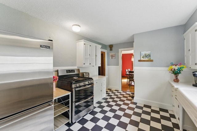 96 Craiwell Ave, West Springfield, MA 01089 - kitchen featuring stainless steel appliances, light flooring, light countertops, and white cabinetry