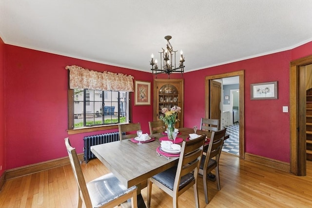 96 Craiwell Ave, West Springfield, MA 01089 - dining space with radiator heating unit, a chandelier, wood finished floors, baseboards, and ornamental molding
