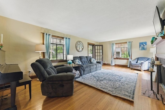 96 Craiwell Ave, West Springfield, MA 01089 - living area featuring a brick fireplace, hardwood / wood-style flooring, baseboards, and a textured ceiling