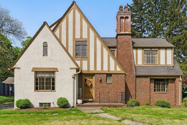 96 Craiwell Ave, West Springfield, MA 01089 - rear view of house with stucco siding, a chimney, a lawn, and a shingled roof