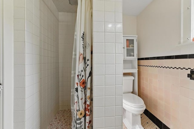 96 Craiwell Ave, West Springfield, MA 01089 - bathroom featuring tile walls, tiled shower, toilet, tile patterned flooring, and a wainscoted wall