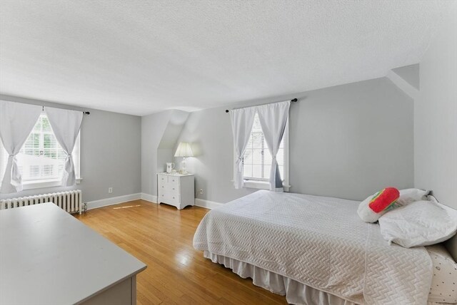 96 Craiwell Ave, West Springfield, MA 01089 - bedroom with radiator, a textured ceiling, wood finished floors, and baseboards