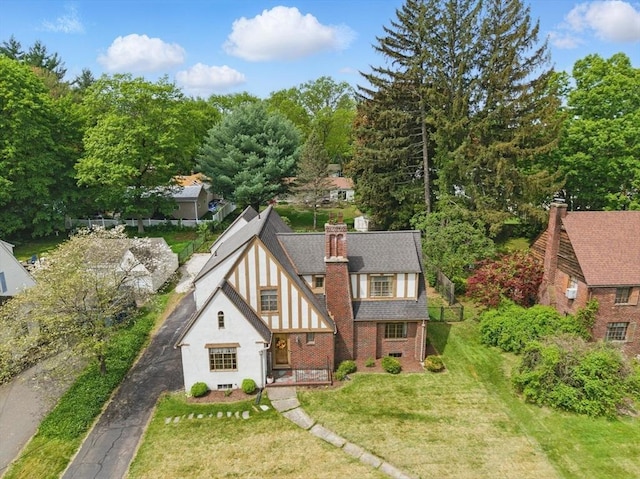96 Craiwell Ave, West Springfield, MA 01089 - view of front facade featuring a front lawn, a chimney, brick siding, stucco siding, and driveway