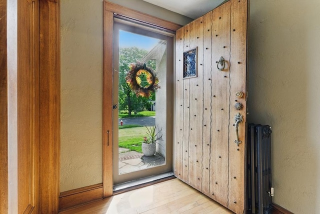 96 Craiwell Ave, West Springfield, MA 01089 - entrance foyer with radiator heating unit, light wood-style floors, and a textured wall