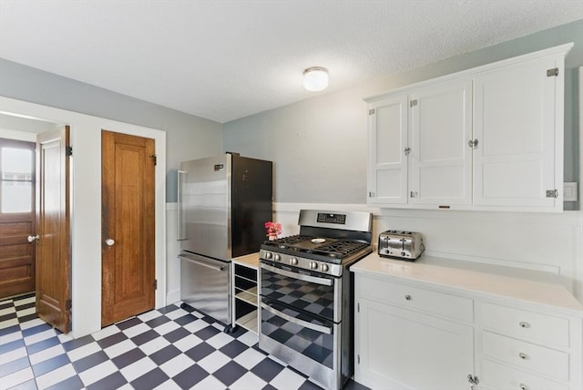 96 Craiwell Ave, West Springfield, MA 01089 - kitchen featuring stainless steel appliances, light flooring, light countertops, white cabinets, and a textured ceiling
