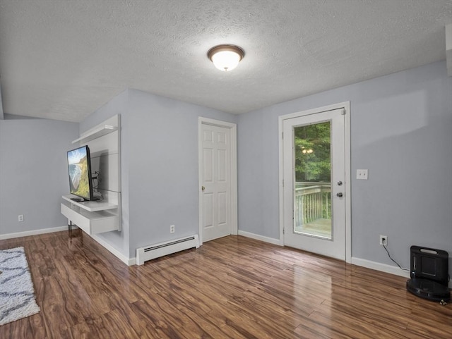 1056 Alger St, Winchendon, MA 01475 - unfurnished living room with a baseboard radiator, wood finished floors, and a textured ceiling