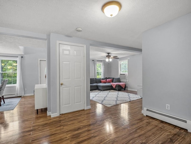 1056 Alger St, Winchendon, MA 01475 - living area featuring baseboard heating, wood finished floors, a textured ceiling, ceiling fan, and cooling unit