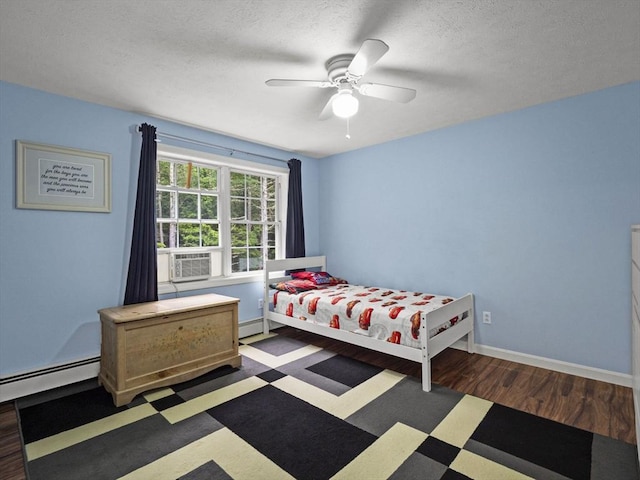 1056 Alger St, Winchendon, MA 01475 - bedroom with wood finished floors, cooling unit, baseboard heating, and a ceiling fan