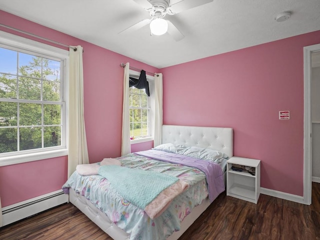 1056 Alger St, Winchendon, MA 01475 - bedroom featuring a baseboard radiator, multiple windows, wood finished floors, and a ceiling fan