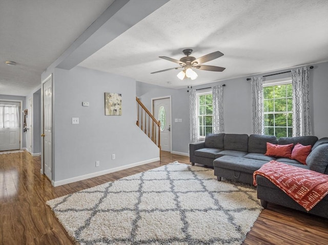 1056 Alger St, Winchendon, MA 01475 - living area with wood finished floors, ceiling fan, stairway, and a textured ceiling