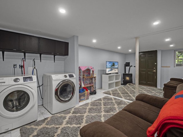 1056 Alger St, Winchendon, MA 01475 - washroom featuring light marble finish flooring, washer and clothes dryer, recessed lighting, and a wood stove