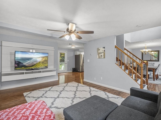 1056 Alger St, Winchendon, MA 01475 - living area featuring stairs, a chandelier, wood finished floors, and a ceiling fan