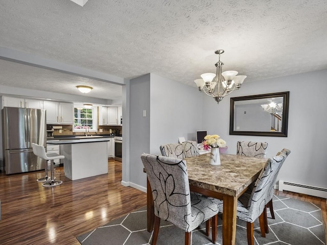1056 Alger St, Winchendon, MA 01475 - dining room with baseboard heating, dark wood-style flooring, a chandelier, and a textured ceiling
