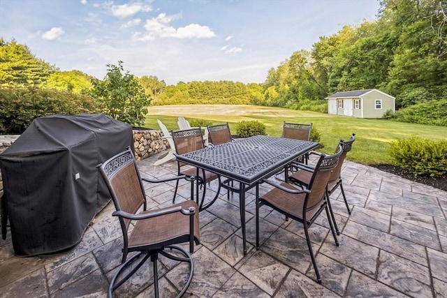 19 Crystal Cir, Tewksbury, MA 01876 - view of patio with area for grilling, outdoor dining space, an outbuilding, and a wooded view
