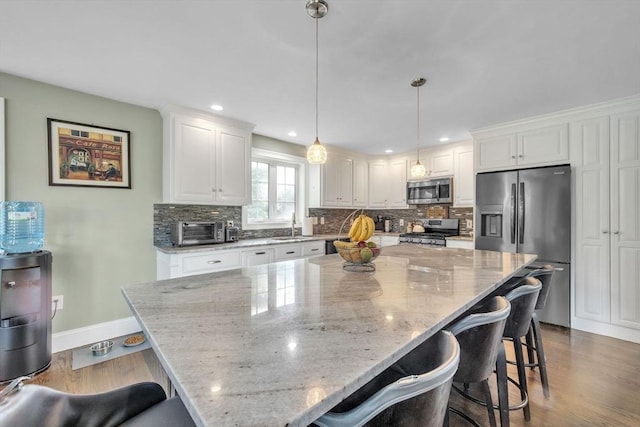 19 Crystal Cir, Tewksbury, MA 01876 - kitchen with stainless steel appliances, backsplash, white cabinetry, and recessed lighting