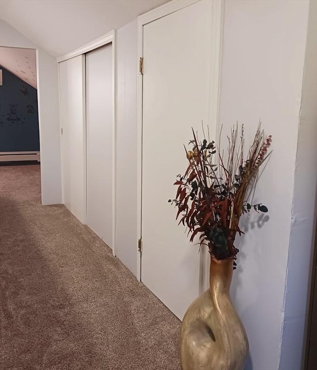 hall featuring carpet and a baseboard heating unit