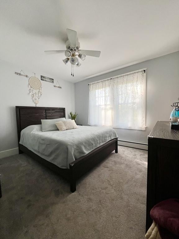 bedroom featuring a baseboard heating unit, carpet, baseboards, and ceiling fan