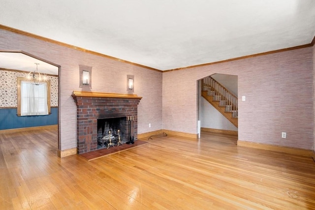 80 Joyce Kilmer Rd, Boston, MA 02132 - unfurnished living room with hardwood / wood-style flooring, stairway, a brick fireplace, a chandelier, and ornamental molding