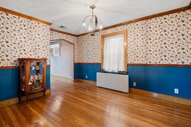 80 Joyce Kilmer Rd, Boston, MA 02132 - spare room featuring radiator, a wainscoted wall, a chandelier, wood-type flooring, and wallpapered walls