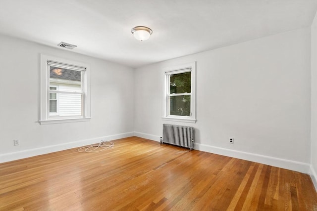 80 Joyce Kilmer Rd, Boston, MA 02132 - unfurnished room with radiator heating unit and light wood-type flooring