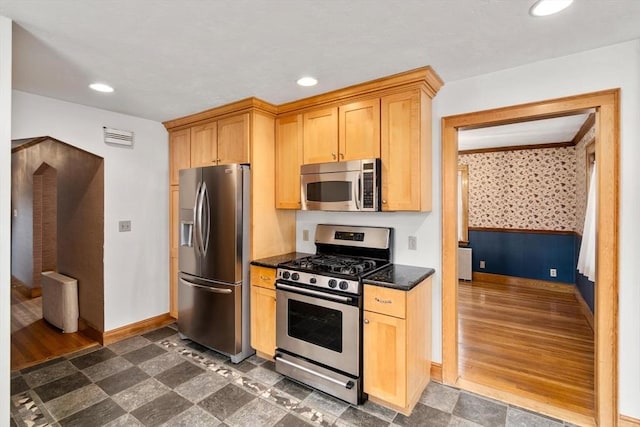 80 Joyce Kilmer Rd, Boston, MA 02132 - kitchen featuring appliances with stainless steel finishes, recessed lighting, wainscoting, dark stone counters, and wallpapered walls