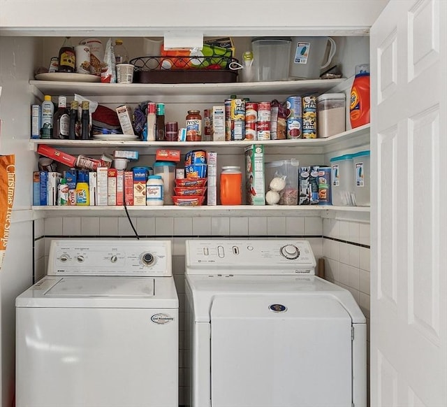 clothes washing area featuring washer and dryer