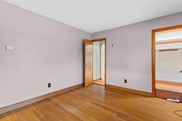 unfurnished bedroom with light wood-type flooring and baseboards