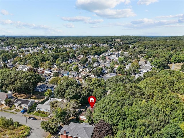 aerial view with a wooded view and a residential view