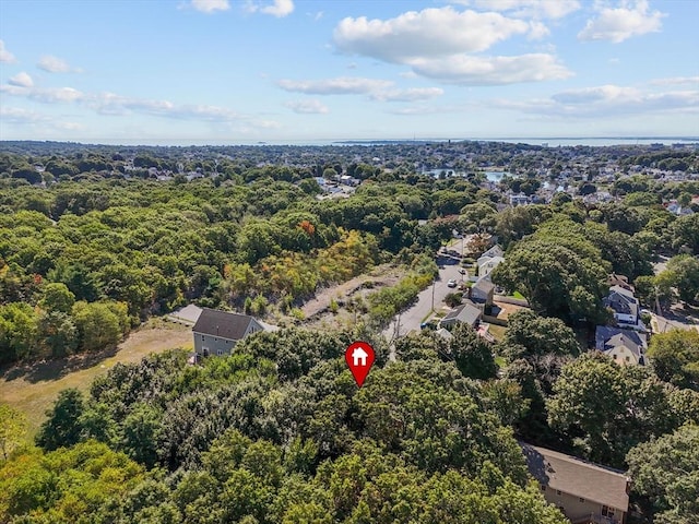 bird's eye view with a wooded view