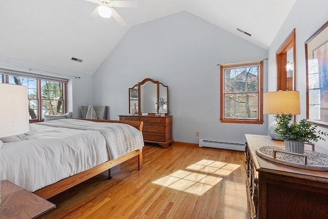 bedroom featuring light wood-style floors, high vaulted ceiling, a baseboard heating unit, and visible vents