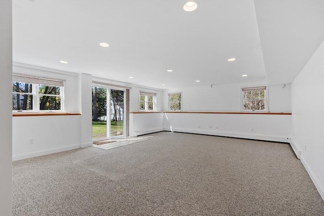 spare room featuring plenty of natural light, carpet flooring, and recessed lighting