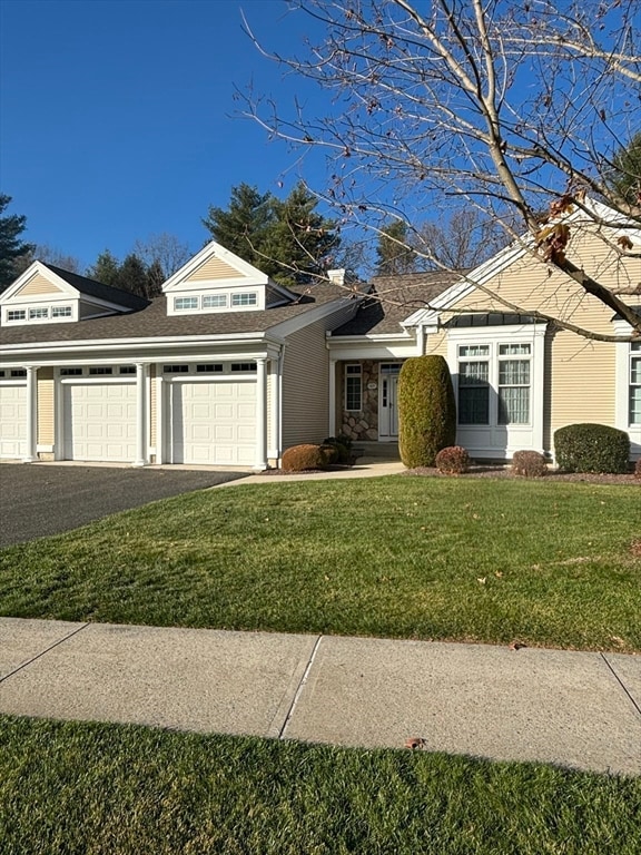 view of front facade with a front lawn and a garage