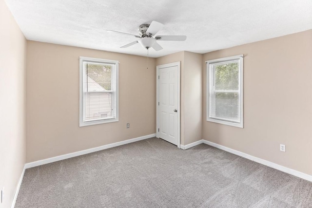 45 Curtis Ave, Attleboro, MA 02703 - unfurnished bedroom featuring carpet flooring, multiple windows, baseboards, a ceiling fan, and a textured ceiling