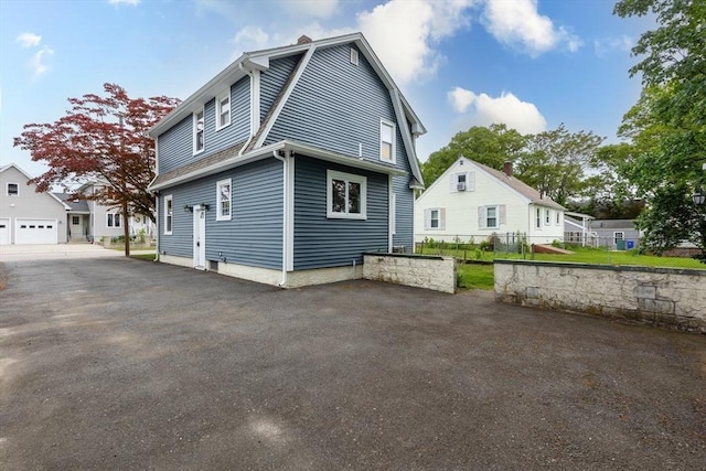 45 Curtis Ave, Attleboro, MA 02703 - view of home's exterior with a chimney and a gambrel roof