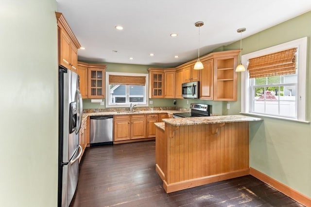 45 Curtis Ave, Attleboro, MA 02703 - kitchen featuring stainless steel appliances, a peninsula, glass insert cabinets, light stone counters, and a sink