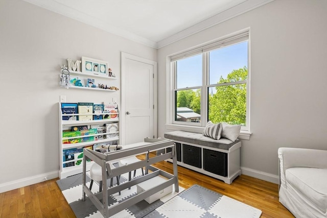 office with ornamental molding, baseboards, and wood finished floors